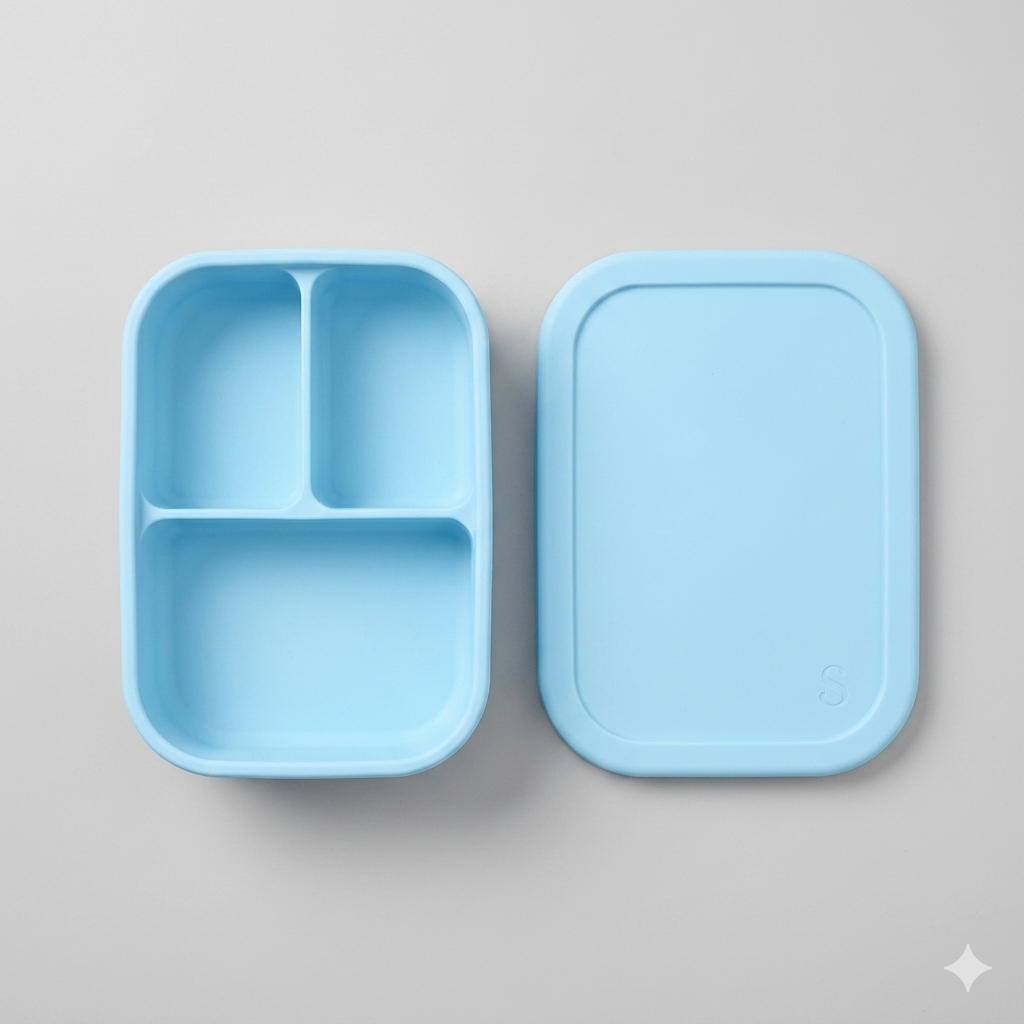 Premium baby blue silicone bento box NZ, medium 3-compartment toddler and school lunch box with matching open lid, bird's-eye view flat lay on bright neutral gray background.