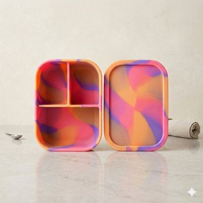 Premium Neon Sunset silicone bento box NZ, 3-compartment leakproof toddler lunch box in vibrant pink orange purple marble swirl pattern, professional studio product shot.