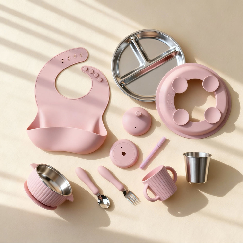 Collection of pink children's dining utensils and accessories on a beige background NZ Aucland