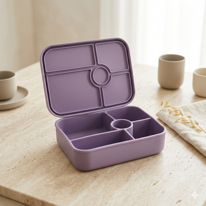 Purple bento box on a wooden table with cups and a towel in the background